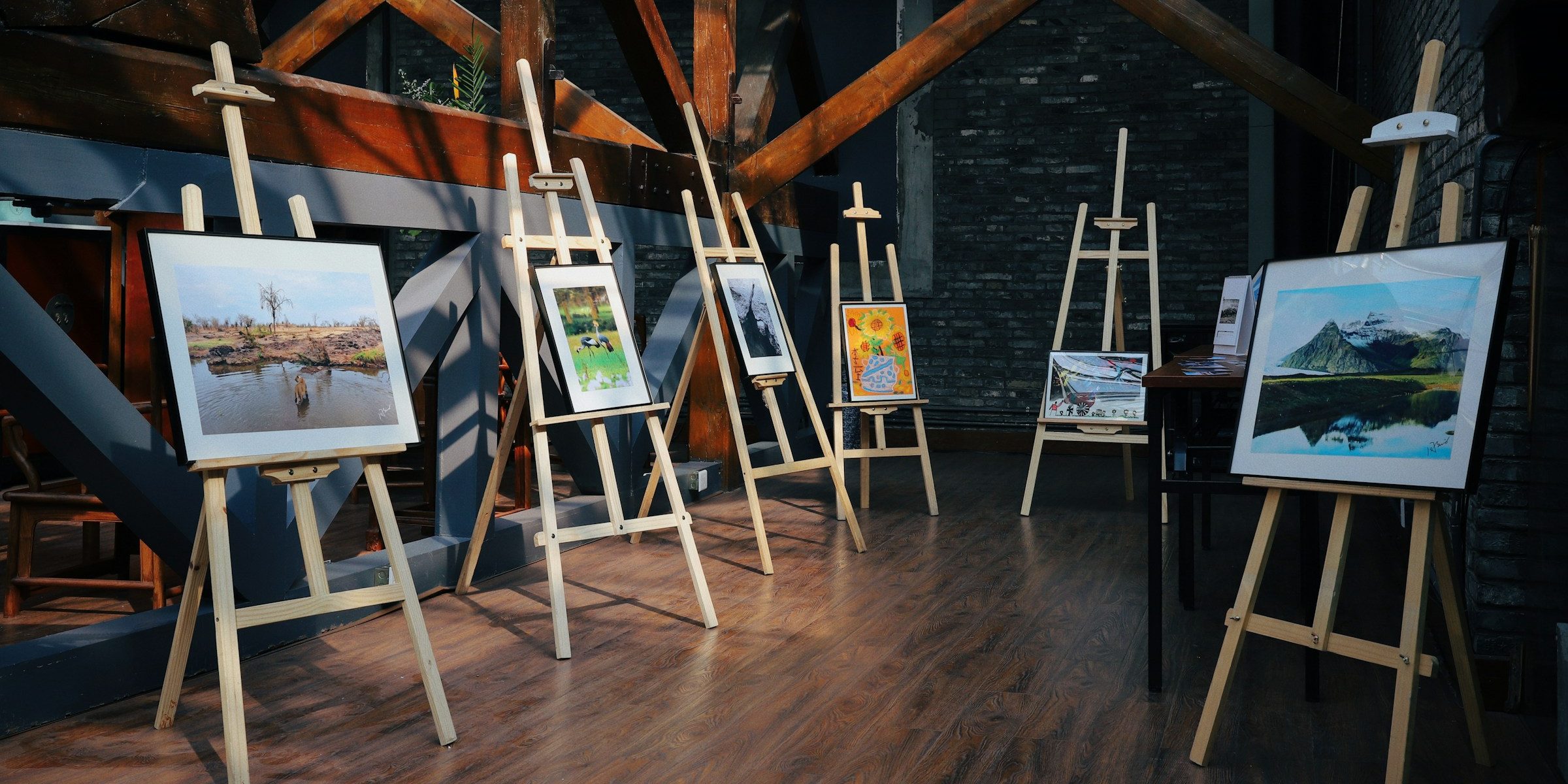 Paintings on wooden easels in a loft studio