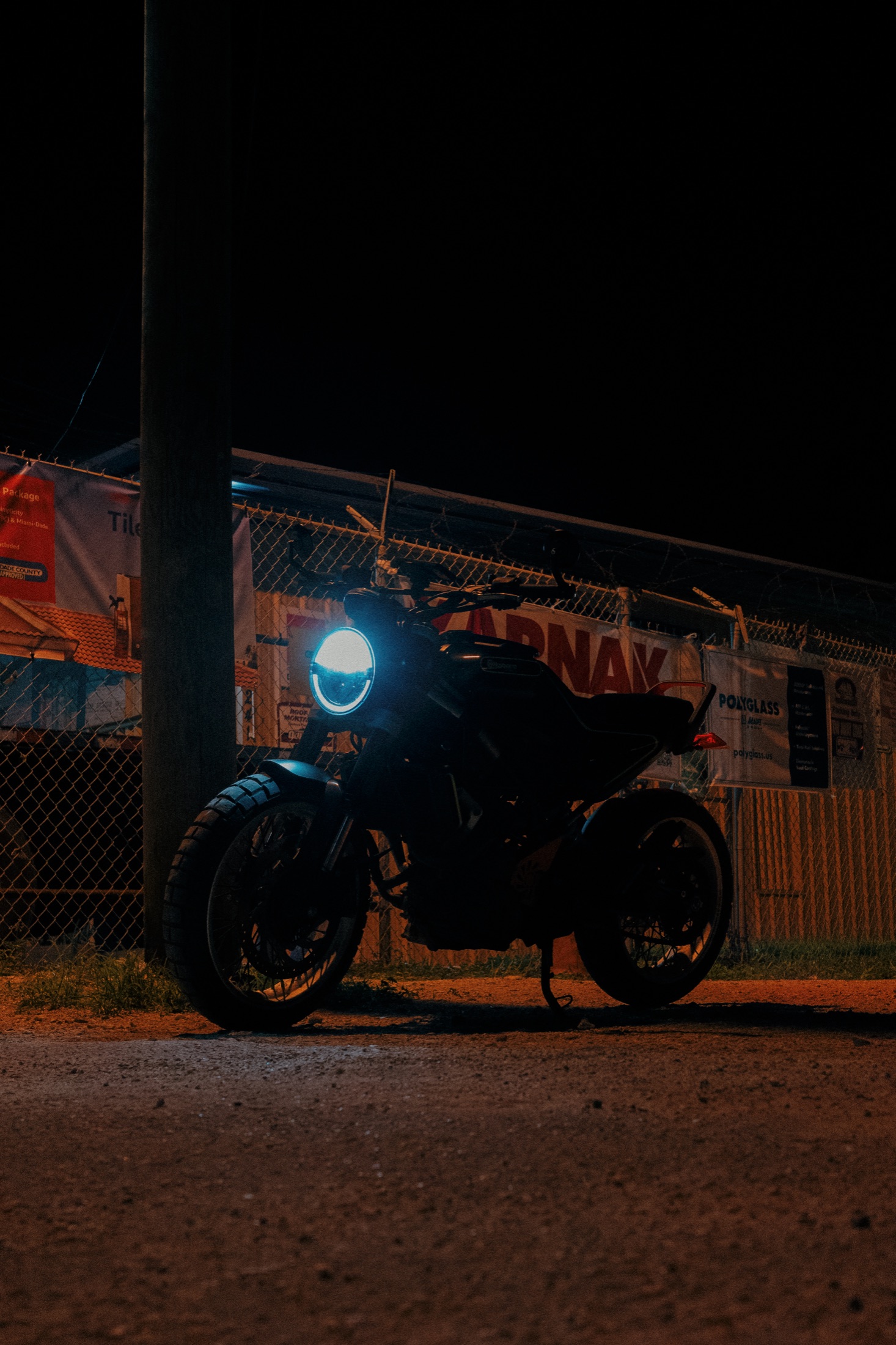 A motorcycle headlight glowing in the dark
